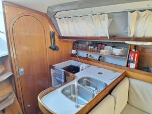 a kitchen with a sink in a room at Be Local - Holidays on the Santa Maria boat with free sunset tour in Lisbon in Lisbon