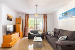a living room with a couch and a tv at Amplio y tranquilo piso para disfrutar del centro de Málaga in Málaga