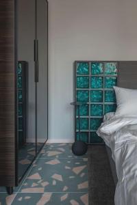 a bedroom with a bed and a large glass window at Resume Apartments, Swimmer Corner No 2 by URBAN RENT in Kaunas
