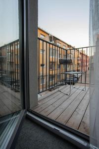 a balcony with a table and a view of a building at Resume Apartments, Swimmer Corner No 2 by URBAN RENT in Kaunas