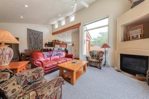 a living room with a red couch and a fireplace at Rim Village L3 in Moab