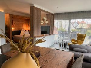 a living room with a table and a couch at Apartments Bogner in Marktbergel