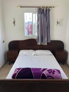 a bedroom with a large bed with a window at Oceana surf house in Imsouane