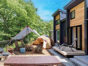 a tent on a patio next to a house at SENKO TINY CAMP - Vacation STAY 29675v in Ueda