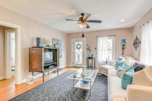 a living room with a couch and a tv at Pet-Friendly Galveston Bungalow, half Mi to Beach! in Galveston