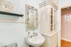 a white bathroom with a sink and a mirror at Pet-Friendly Galveston Bungalow, half Mi to Beach! in Galveston +22 photos