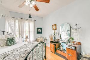 a bedroom with a bed and a mirror at Pet-Friendly Galveston Bungalow, half Mi to Beach! in Galveston