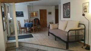 a living room with a couch and a table at Wohnung in Bad Ditzenbach mit Eigenem Garten in Bad Ditzenbach