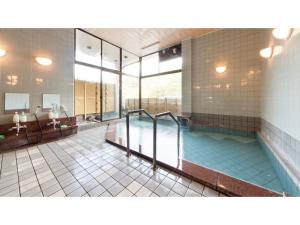 un ampio bagno con piscina e vasca di Shimaonsen AYAMEYA Ryokan - Vacation STAY 20611v a Shima
