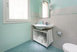 a bathroom with a sink and a toilet and a mirror at Appartement in Scandiano mit Privatem Parkplatz - b56491 in Scandiano