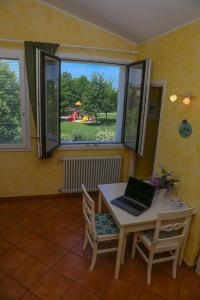 a room with a table with a laptop on it at Appartement in Scandiano mit Privatem Parkplatz - b56491 in Scandiano