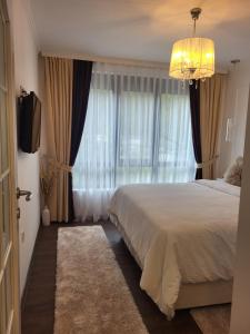 a bedroom with a large bed and a chandelier at Luxury apartment in Teteven