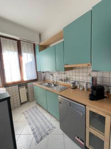 a kitchen with blue cabinets and a sink at La casa di Ciccio in Limite +9 photos