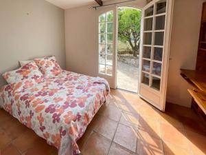 1 dormitorio con 1 cama y puerta corredera de cristal en Charmante Villa au Calme Absolu, en Niza