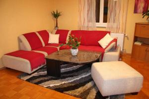 a living room with a red couch and a coffee table at Wunderschönes Ferienhaus in Zainingen mit Eigener Terrasse in Zainingen