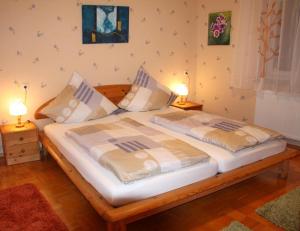 a bedroom with a bed with two pillows on it at Wunderschönes Ferienhaus in Zainingen mit Eigener Terrasse in Zainingen