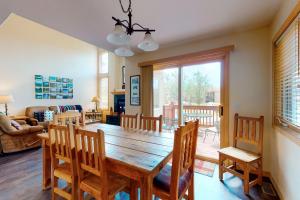 a dining room with a wooden table and chairs at Cascades Townhomes by Steamboat Resorts in Steamboat Springs