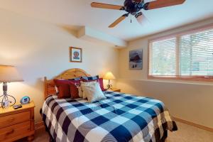 a bedroom with a bed and a ceiling fan at Cascades Townhomes by Steamboat Resorts in Steamboat Springs
