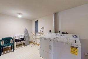 a kitchen with a washer and dryer in a room at Cascades Townhomes by Steamboat Resorts in Steamboat Springs +16 photos