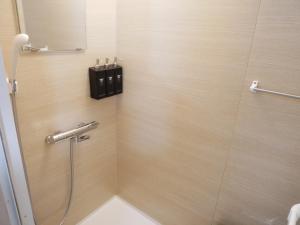 a bathroom with a shower with a black box on the wall at HOOD - Vacation STAY 19682v in Amami