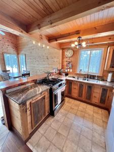 a large kitchen with a stove and a sink at THE RIVER HOUSE LIMIT 6 home 