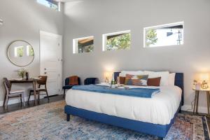 a bedroom with a blue and white bed and a table at New Casita in Deer Creek Area in Dripping Springs