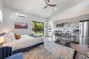 a bedroom with a large bed and a kitchen at New Casita in Deer Creek Area in Dripping Springs