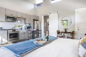 a large white kitchen with a white bed in a room at New Casita in Deer Creek Area in Dripping Springs
