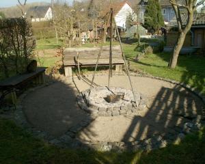 a playground with a wooden bench in a yard at Appartement in Berlingen mit Garten, Terrasse und Grill in Berlingen