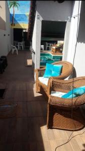une chambre avec des chaises en osier et une piscine dans l'établissement Casa mobiliada para periodo TECNOSHOW, à Rio Verde