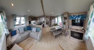 an aerial view of a living room and kitchen in an rv at Luxurious caravan in Lyons Holiday Park Rhyl in Meliden
