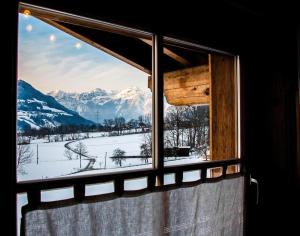 a window with a view of a snow covered mountain at Ferienhaus in Hart Im Zillertal mit Eigenem Balkon in Hart im Zillertal