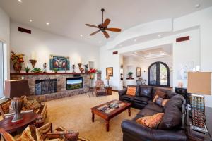 a living room with a couch and a fireplace at Scottsdale - 35982 N Willow Cross Dr in Cave Creek