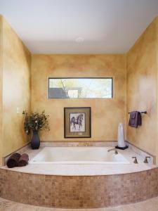 a large bath tub in a bathroom with a window at Scottsdale - 35982 N Willow Cross Dr in Cave Creek