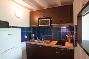 Kuchyň nebo kuchyňský kout v ubytování Bungalow Palm