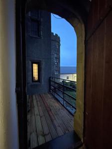 an open door to a balcony with a view of a building at Lower Harbour watch in Holyhead