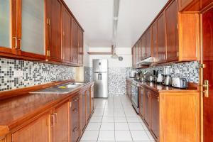 a kitchen with wooden cabinets and a refrigerator at Oceanfront Miraflores Larcomar next to Marriott in Lima