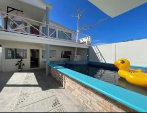 a house with a swimming pool with a rubber duck in the water at Casa rossi in Tecolutla