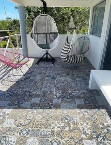 a patio with chairs and a mosaic floor at Casa rossi in Tecolutla