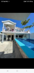 a large house with a swimming pool in front of it at Casa rossi in Tecolutla