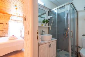 a bathroom with a sink and a shower at İmerek Taş Ev Otel Alaçatı in Alaçatı +40 photos