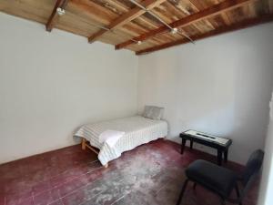 a room with a bed and a table and a chair at OCALA HOUSE 4.0 in Huánuco