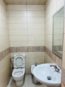 a bathroom with a toilet and a sink at Apartment Cheap in Agadir