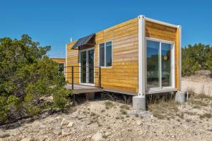 a tiny house on a hill with a porch at Hill Country Norwood Tiny Home B- Sits on 13 Acres, Sleeps 2 and Pet Friendly! in Dripping Springs