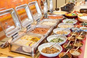 a buffet with many trays of food on a table at Hotel Taiko - Vacation STAY 21755v in Myoko