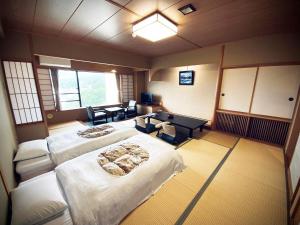 a large room with two beds and a desk at Hotel Taiko - Vacation STAY 21755v in Myoko