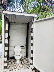 a toilet sitting inside of a small garage at ALAROOTS BORA BORA CAMP in Bora Bora