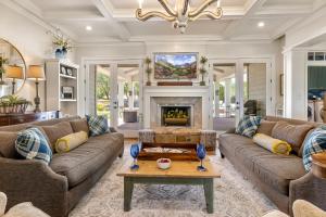 a living room with two couches and a fireplace at Peaceful Country Charm with Private Pool in Dripping Springs