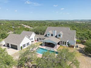 an aerial view of a house with a swimming pool at Peaceful Country Charm with Private Pool in Dripping Springs