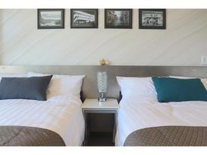 two beds sitting next to each other in a bedroom at Sakuraya - Vacation STAY 14453v in Takahara